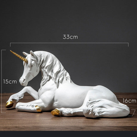 White unicorn figurine with gold hooves and horn on a wooden surface, measurements indicated.