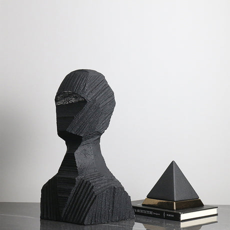 Abstract black sculpture on a reflective surface with a white background